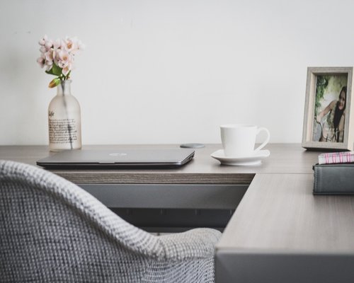 Woman stretching arms at office desk